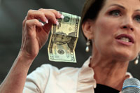 Michele Bachmann holding a 20 dollar bill