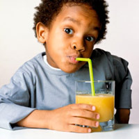 Baby drinking orange juice