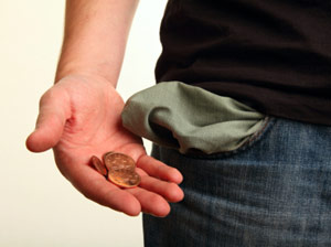 Poor man pulling pennies out of his pocket