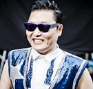 PSY in a cutoff vest with a glitter star