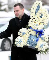 Flower arrangement inthe shape of a rabbit carried by a man