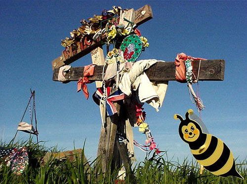 Roadside cross memorial with a bumblebee