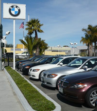 Six BMWs at the dealership parking lot