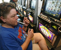 Woman smoking at the slots at a casino