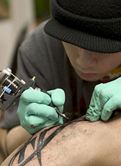 Tattoo needle and arm