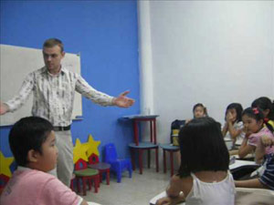 Man teaching kids in Asia