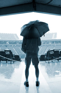 Guy staring at a rain-soaked US Open tennis stadium