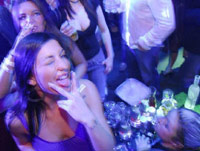 Girl sticking tongue out in VIP section of a club
