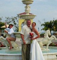 Guy acting stupid in a fountain behind a wedding picture