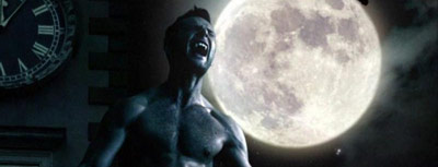 Man turning into a werewolf in front of a full moon