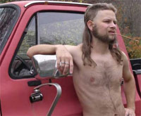White trash guy with a mullet leaning on a pickup truck