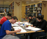 4 people studying at a table in the WVU library