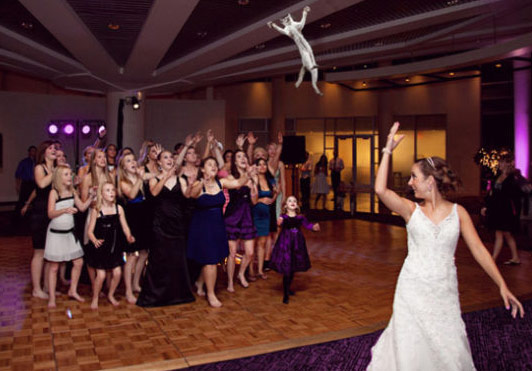 Bride tosses a doll into crowd
