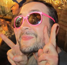 Casey Freeman wearing sunglasses giving the peace sign
