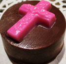 Chocolate cookie with a Christian cross in frosting