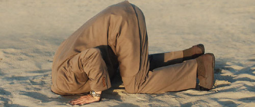 Man with his head in the sand crying