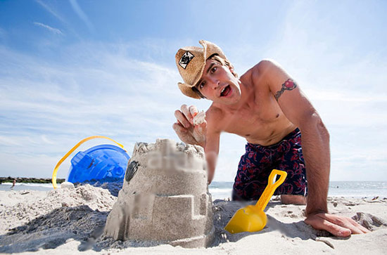 Guy building a sandcastle at the beach
