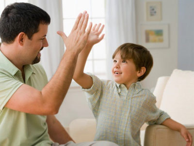 Kid high fiving an adult