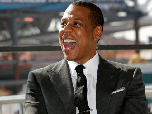 Jay Z in a black suit laughing