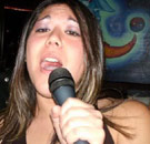 Woman singing karaoke at the bar
