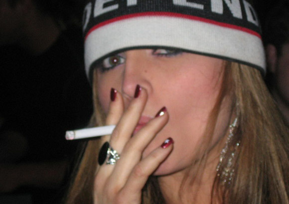 Slut girl smokes a cigarette