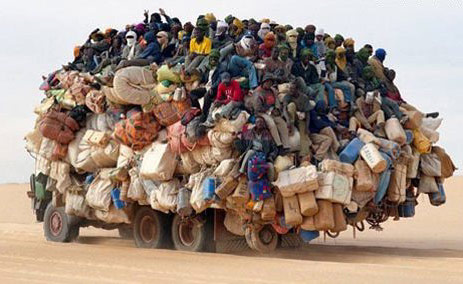 Overcrowded truck in the desert