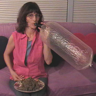 Woman inhaling weed smoke from Volcano bag