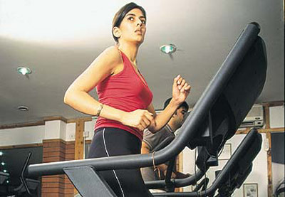 Woman running on treadmill at the gym