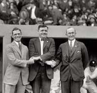 Babe Ruth and Ty Cobb pose for a picture on a baseball field