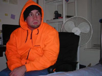 Casey in an orange hoodie, contemplative