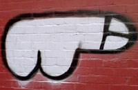 Graffiti penis on a brick wall
