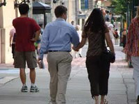 Couple holding hands on the sidewalk