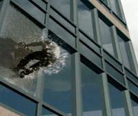 Guy being thrown out a glass window building