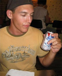 Guy drinking Pabst Blue Ribbon (PBR) in a bar