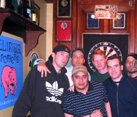 5 guys at a sports bar playing darts