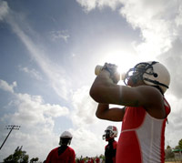 Kid overheating in the sun during high school football practice