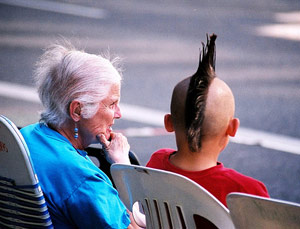 Old woman talking to young boy with mohawk