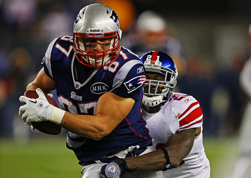 NY Giants player tackling a New England Patriots player in Super Bowl