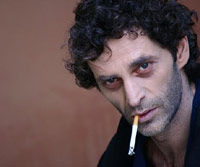 Man smoking a cigarette, teary eyes