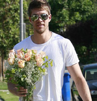 Guy bringing surprise flowers to his girlfriend