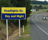 Road sign: Headlights on, day and night