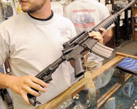 Guy holds a semi-automatic rifle