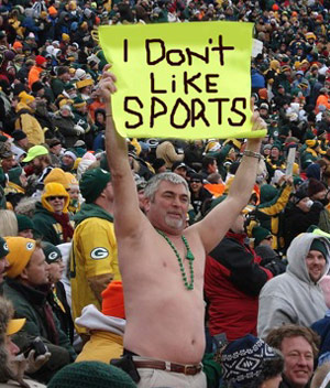 Guy in stands at sports event holding sign that says I Don't Like Sports