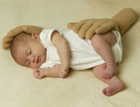 Infant on blanket with fake gloved hands