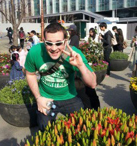 Casey holding up a peace sign in a green Irish Star Trek shirt