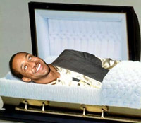 Jaleel White laying in a coffin smiling