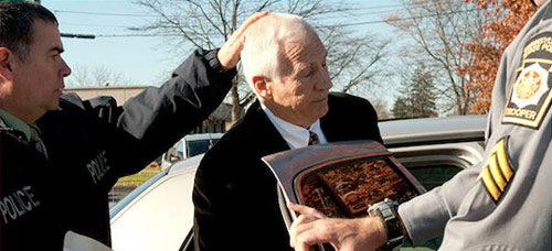 Jerry Sandusky getting into a police car