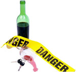 Keys, wine glass and danger tape