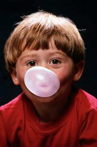 Kid blowing bubbles with gum