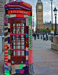 Telephone booth covered in knitting